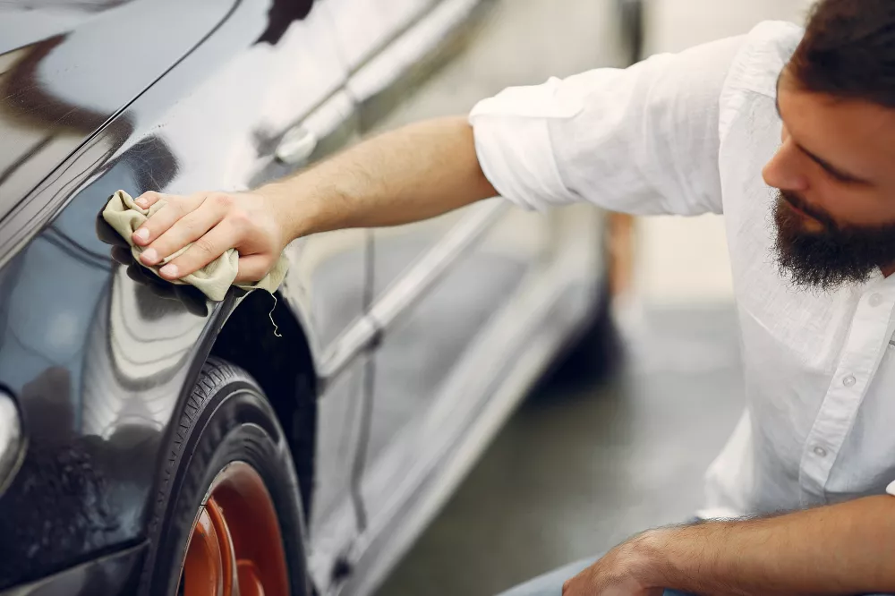 man-white-shirt-wipes-car-car-wash