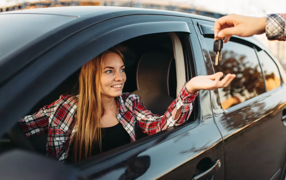male-hand-gives-car-keys-female-driver