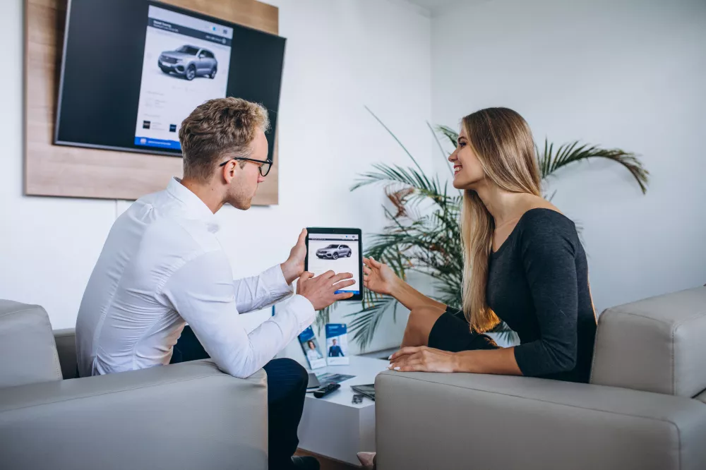 man-woman-car-showroom-using-tablet